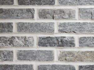 Closeup of Silver Pearl Stone Brick thin brick veneer shown with white mortar