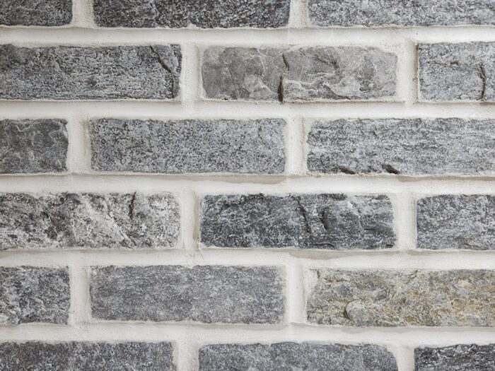 Closeup of Silver Pearl Stone Brick thin brick veneer shown with white mortar