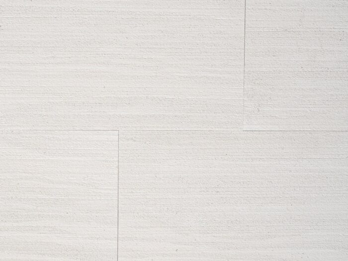 Closeup of AllClad Calypso Linear Raked natural stone tile product