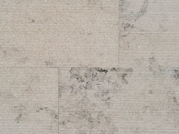 Closeup of AllClad Gaia Linear Raked natural stone tile product