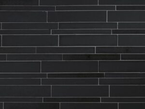 Close-up of ebony basalt lynia natural stone veneer on mesh product