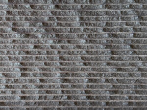 Closeup of AllClad Tahitian Black Split Chipped natural stone tile product